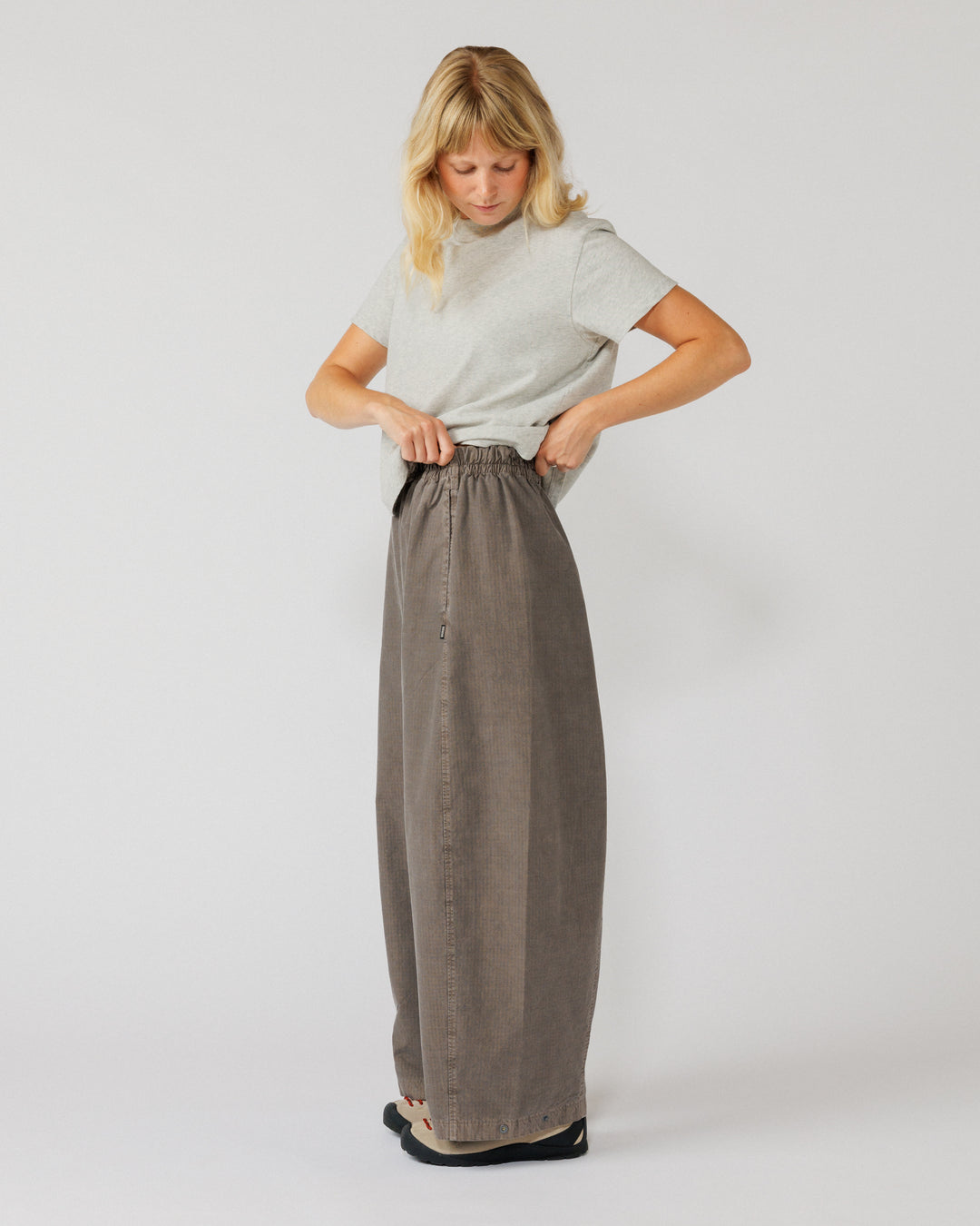 Garment Dyed Atlas Pants - Fawn Brown — action shot, elastic waist shown