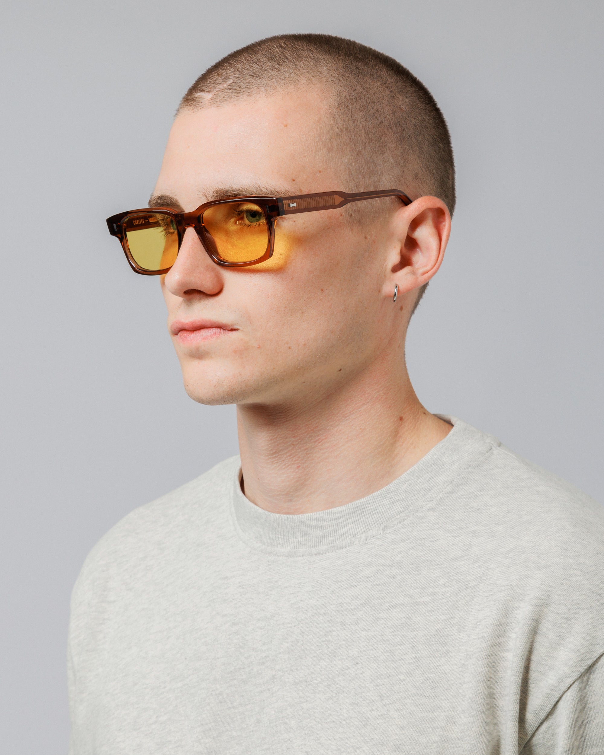 Model wearing Solaris Sunglasses in coconut, three-quarter view