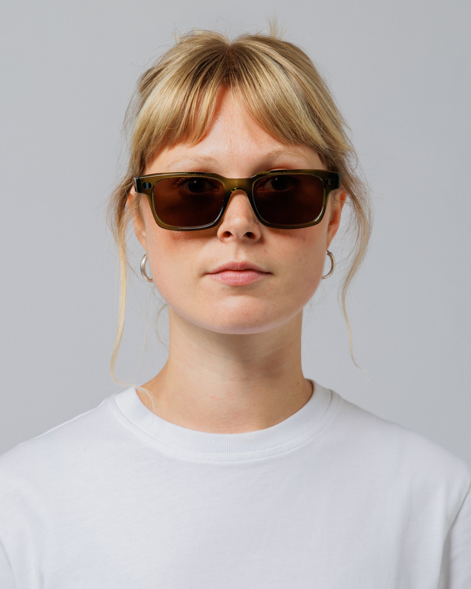 Model wearing Solaris Sunglasses in khaki, front view