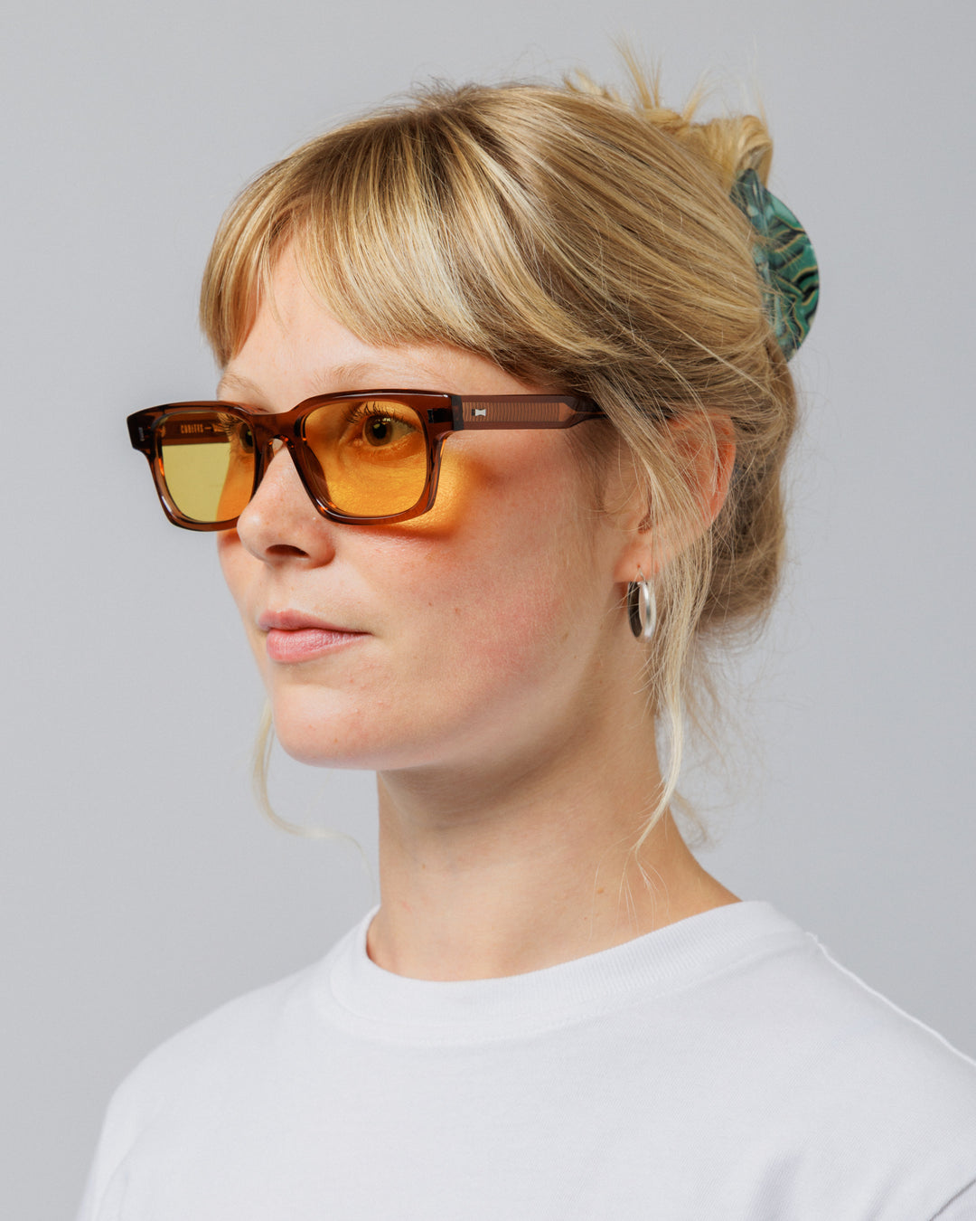 Female model wearing Solaris Sunglasses in coconut, three-quarter view