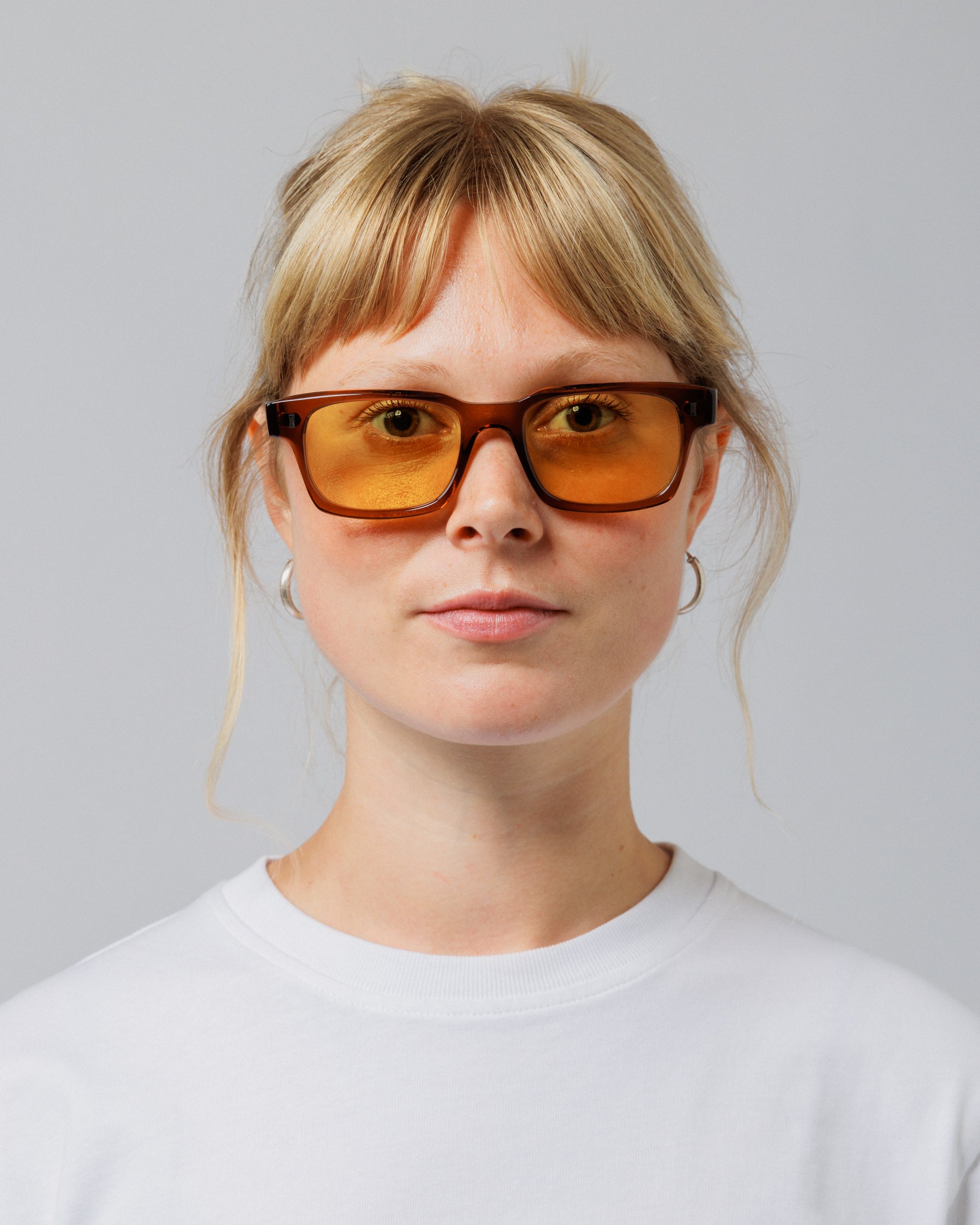 Female model wearing Solaris Sunglasses in coconut, front view