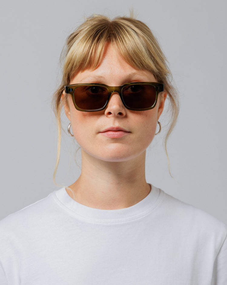 Female model wearing Solaris Sunglasses in khaki, front view