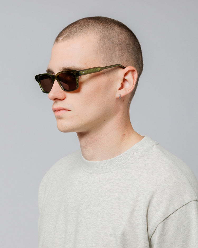 Male model wearing Solaris Sunglasses in khaki, three-quarter view